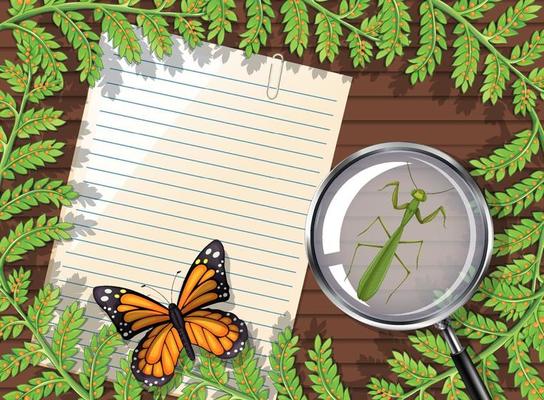 Top view of blank paper on table with leaves and insects elements