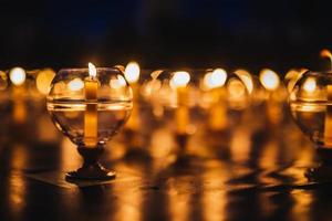 Candles in glass on the floor decorated for prayer ceremony in church photo