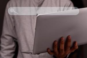 Man uses a notebook computer to find information photo