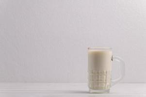 A glass of milk on the desk photo