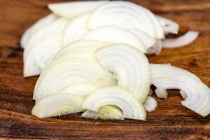 White onion sliced on wood planks photo