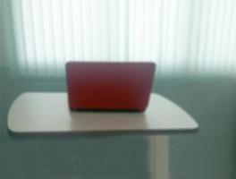 Blurred background notebook on table with blind light curtain