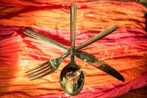 Fork and spoon in front of colorful background photo