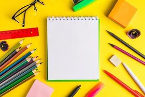 Set of school supplies on yellow background with copy spce photo