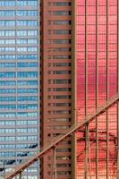 Geometrical patterns on building facade with sky and cloud reflections photo