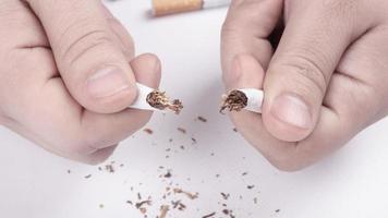 Broken cigarette in hand close-up, stop smoking photo