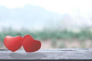 Romantic love heart shapes on wooden table photo