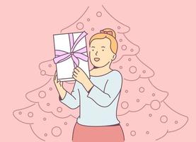 Christmas or New year concept. Young cheerful blonde girl holding gift box and rejoices. Christmas holiday celebration, winter season tradition. vector