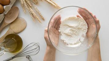 Top view hands holding bowl with flour photo