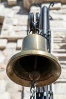 Bronze bell close-up on the wall background photo