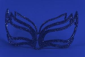 A mask made of blue crystals on a blue background. photo