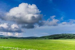 landscape with white clouds on the blue sky flying photo