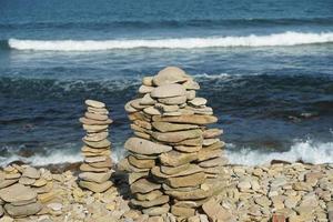 Seascape with pyramids of stones photo