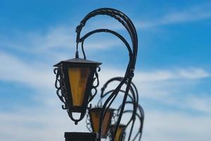 beautiful vintage lanterns on blue sky background. photo