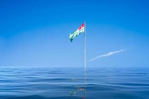 the flag of Abkhazia on the background of blue sky and clouds photo