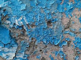 Fondo azul con pintura al óleo agrietada sobre yeso. foto