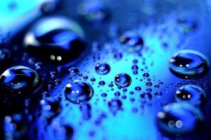 Macro image of droplets on shiny surfae. photo