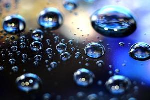 Macro image of droplets on shiny surfae. photo