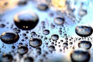 Macro image of droplets on shiny surface. photo