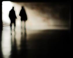 Blurry moving silhouettes in an underground passage. photo