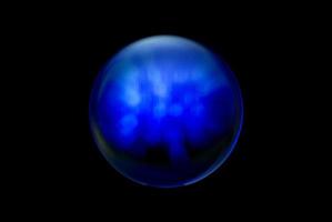 An abstract sphere with a blurry pattern isolated on black background. photo