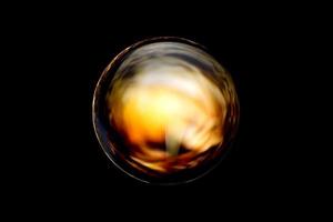 una esfera abstracta con un patrón borroso aislado sobre fondo negro. foto