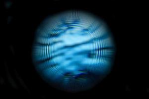 An abstract sphere with a blurry pattern isolated on black background. photo