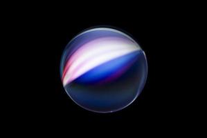 An abstract sphere with a blurry pattern isolated on black background. photo