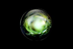 An abstract sphere with a blurry pattern isolated on black background. photo