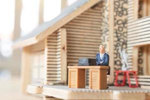 Miniature businesspeople working at home to protect themselves from coronavirus, work from home concept photo