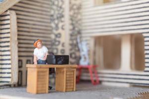 Miniature businesspeople working at home to protect themselves from coronavirus, work from home concept photo