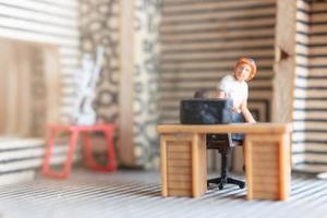 Miniature businesspeople working at home to protect themselves from coronavirus, work from home concept photo