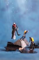 Miniature people, scuba divers clean up plastic rubbish pollution discarded in the ocean, underwater pollution concept photo