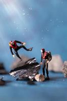 Miniature people, scuba divers clean up plastic rubbish pollution discarded in the ocean, underwater pollution concept photo