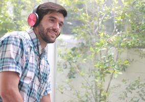 Handsome man happily listening to music photo