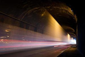A dark tunnel with light trails