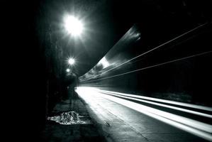 A dark tunnel with light trails photo