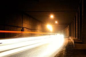 A dark tunnel with light trails