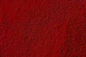 Textured red background of the wall plaster photo