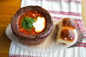 Borscht in black bread with dumplings photo