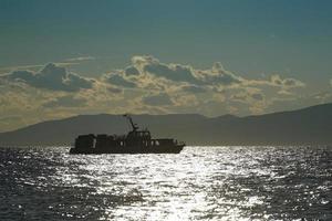 Silhouette of the ship against the seascape photo