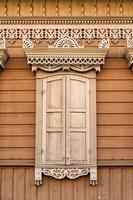 Facade of a wooden building with a window. photo