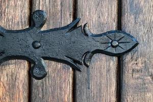 black metal decorative element on wooden doors photo