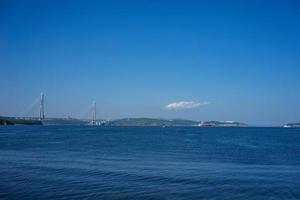 Marine landscape with views of the Russian bridge on the horizon. photo