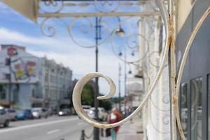 White metal lace on a blurred urban background. photo