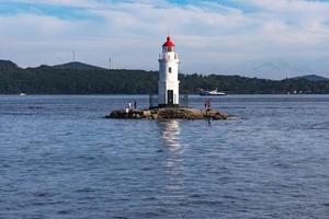 Seascape with a view of the lighthouse against the sea. photo