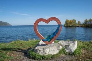 Sculpture of a heart on the shore of Lake Baikal. photo
