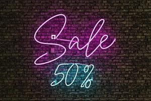Realistic neon lamp with the word SALE and discount number photo