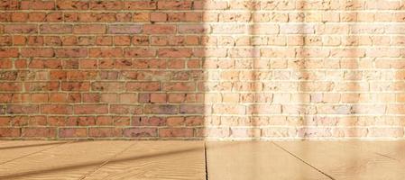 Wooden table with blurred brick wall with window illumination photo