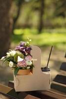 Bouquet and coffee in a to-go container outside photo